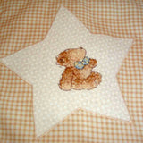 close up of a star with a cross-stitched bear